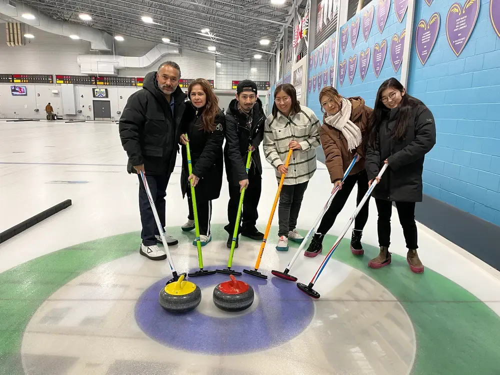 Bayswater Vancouver students taking part in a curling activity shown in the official campus gallery