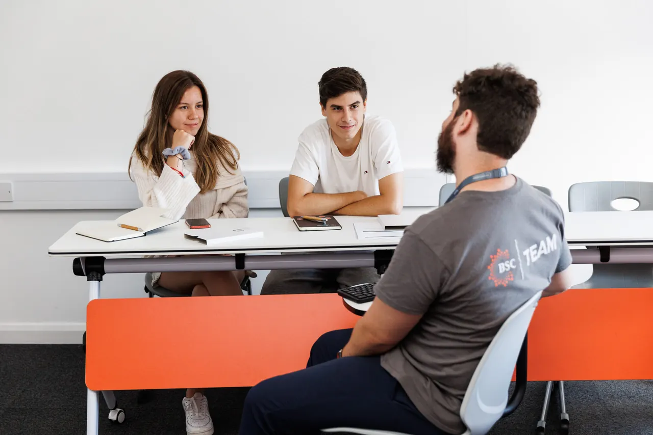 A teacher leading a small-group tutorial at BSC Brighton
