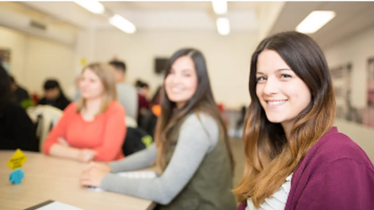 Discover English — Students studying at a classroom table