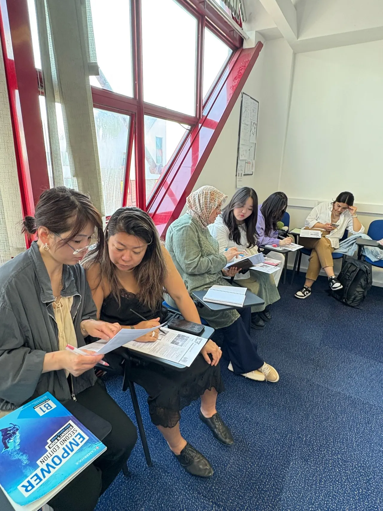 Influential English — Students seated together for a classroom discussion