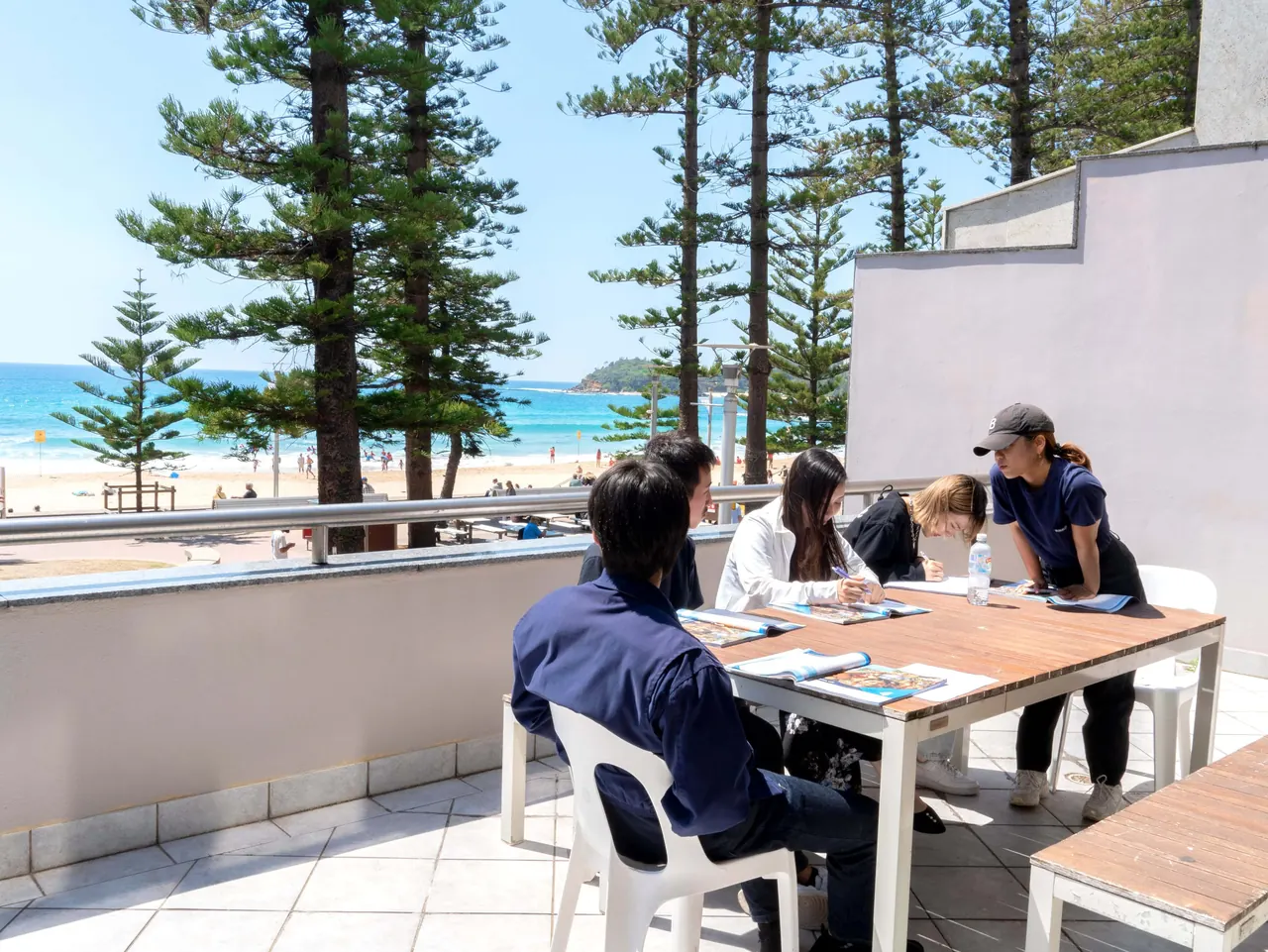 Lexis Sydney campus balcony — students seated around a table