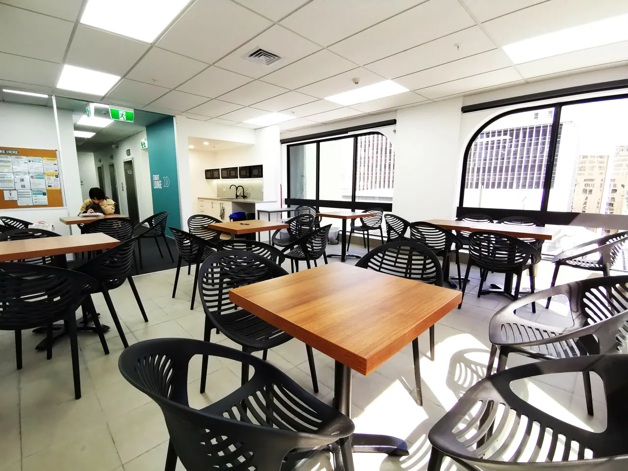 Bright classroom with group tables at NZLC Auckland