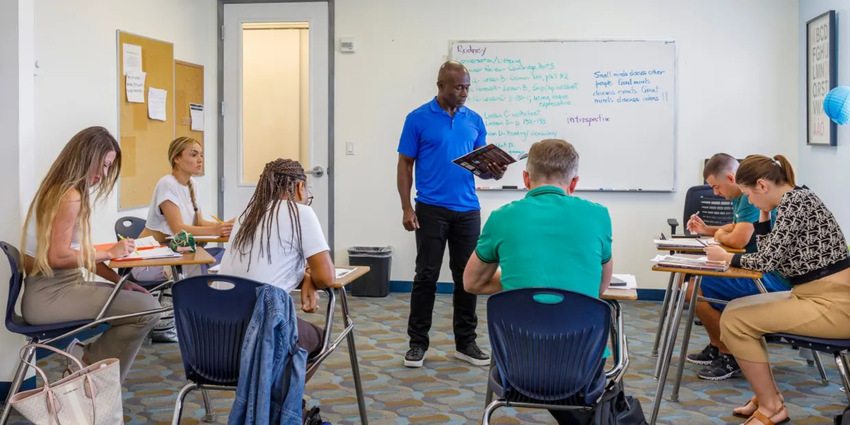 A teacher and students in a classroom at OHC English Miami
