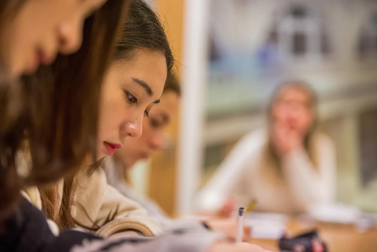 Oxford School of English — Students and a teacher in a close view of a classroom